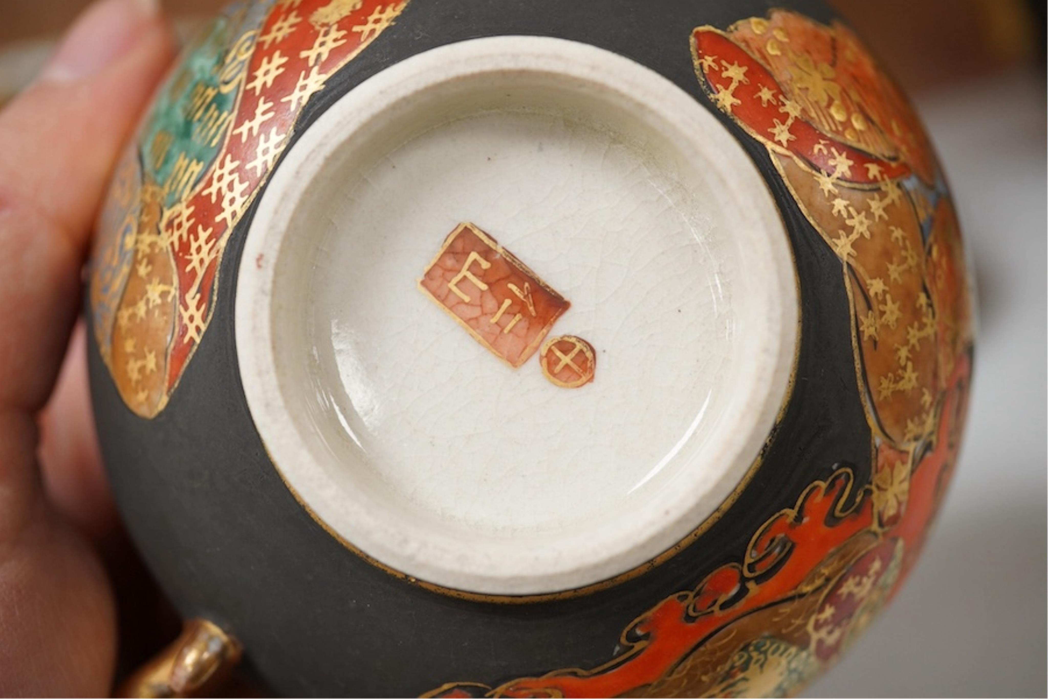 A Japanese Satsuma pottery enamel decorated tea set with Kwannon and rakan, teapot and cover 18cm high. Condition - one cup missing, one cup cracked